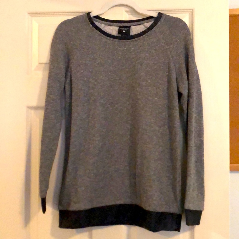 Sweater with leather detailing around the edges. Soft inside